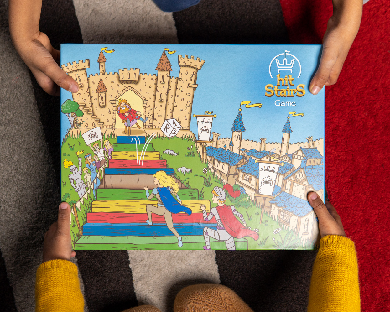 Des enfants tiennent la boîte de Hit StairS Game